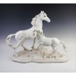 A plaster of paris model of a horse and a foal, modelled standing, each with painted eye detail,
