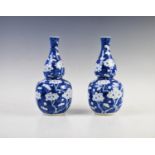 A pair of Chinese blue and white gourd vases, late 19th century, each of typical double gourd form