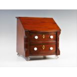 A Victorian style mahogany apprentice davenport, with a hinged front over two bow front drawers,