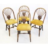 A set of four late 19th/early 20th century stained beech wood kitchen chairs, the hoop backs with