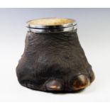A 19th century white metal mounted elephants foot, with hinged cover and wooden liner, 30cm high