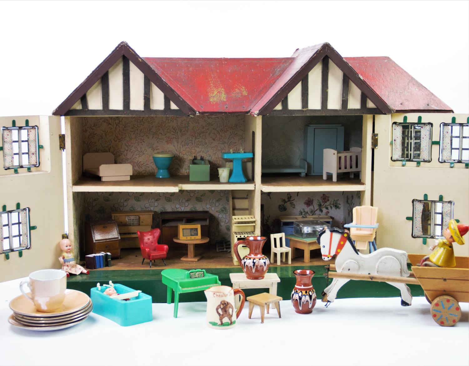 A 1930's black and white dolls house, with a red roof and hinged front, concealing four rooms and - Image 2 of 2