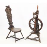 A 19th century oak spinning wheel, the 41cm wheel with six turned spindles, raised upon turned out-