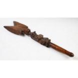 A Yoruba Shango wand, Nigerian wood, carved as a kneeling female holding an offering bowl, with a