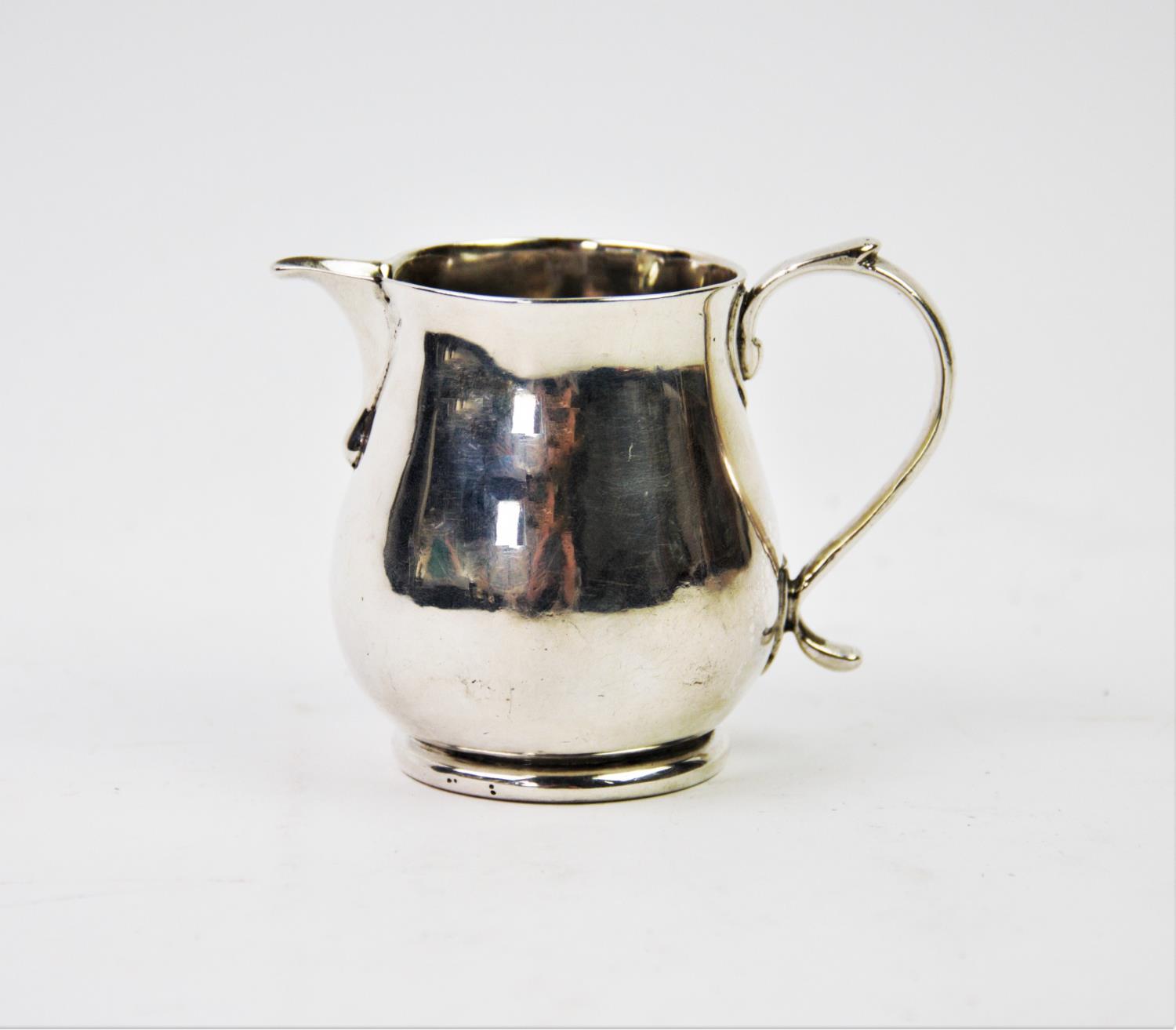 A George I silver cream jug, James Goodwin, London 1718, of plain polished form, with sparrow beak
