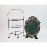 An Art Nouveau mirror, of oval form, decorated with flora and butterflies, easel back, 31cm high,