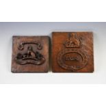 Two 19th century oak plaquettes, decorated with the Beswicke-Royds Family Crest and the Latin