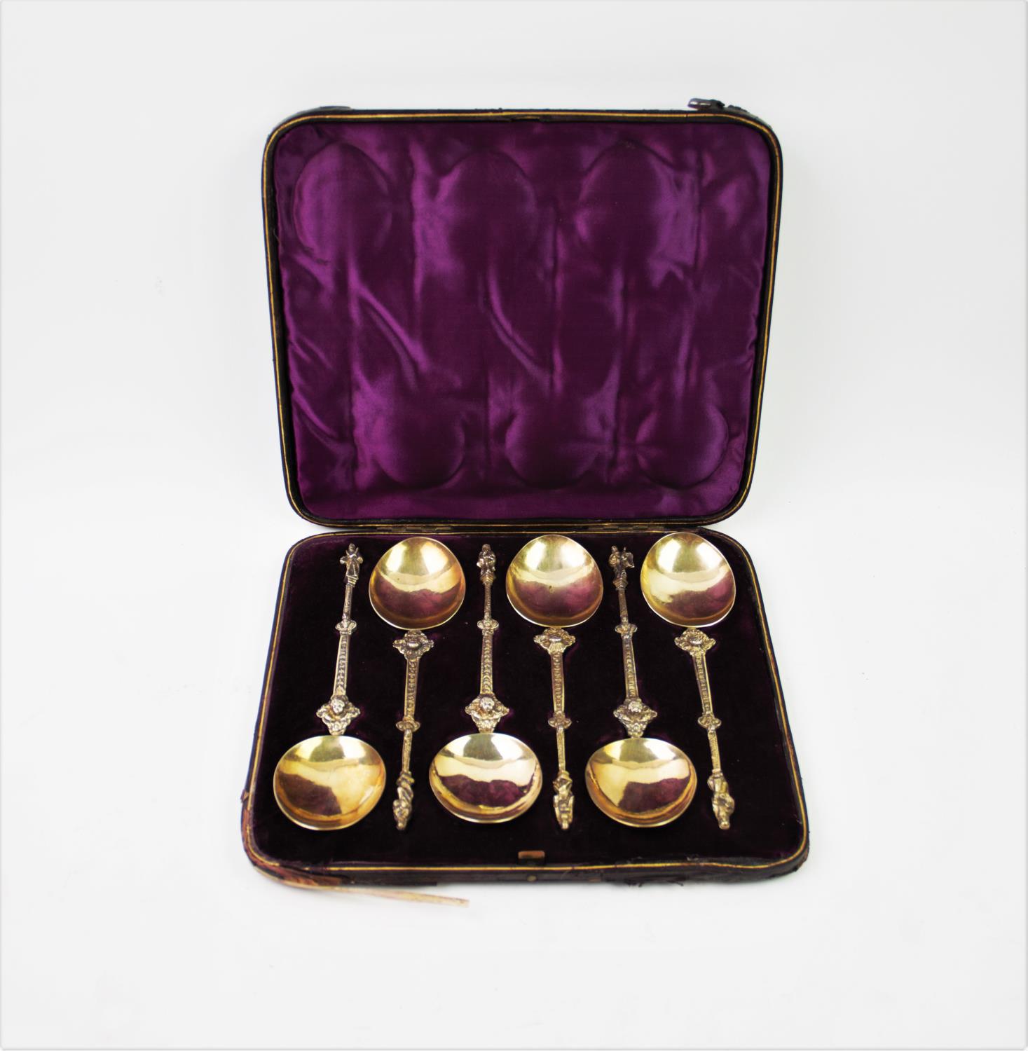 A set of six continental white metal and gilt apostle spoons, with oval bowls, chased stems