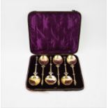 A set of six continental white metal and gilt apostle spoons, with oval bowls, chased stems
