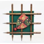 A novelty sporting wall hanging coat/hat rack, constructed with a central painted shield shaped coat