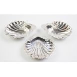 A pair of Victorian silver butter dishes in the form of scallop shells on three ball feet by Sibray,