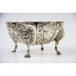 A continental white metal bowl, the floral form bowl, with eight defined panels, decorated with a