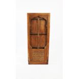An Indian carved hardwood door with frame, the hinged doors with metal banding above a pair of