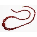 A cherry amber bead necklace, the single strand necklace comprising graduated beads strung on