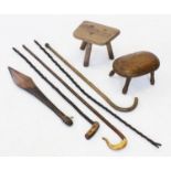 A 19th century elm milking stool, a second oval stool on four legs, along with four assorted walking