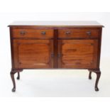 An early 20th century mahogany sideboard, with two frieze drawers above a pair of cupboard doors,