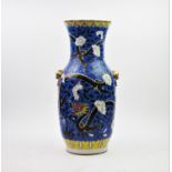A Chinese porcelain famille noire vase, 19th century, of baluster form with twin lions mask and ring