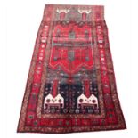 A heavy piled red ground Persian village carpet with a bespoke design, 330cm x 146cm