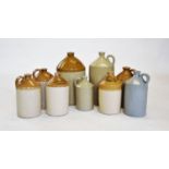 A collection of nine stoneware flagons, of typical cylindrical form, stamped with various