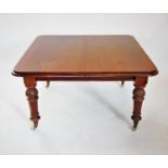 A Victorian mahogany extending dining table, the rectangular moulded top with rounded corners,