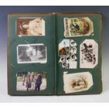 An early 20th century postcard album, containing a selection of postcards, to include British