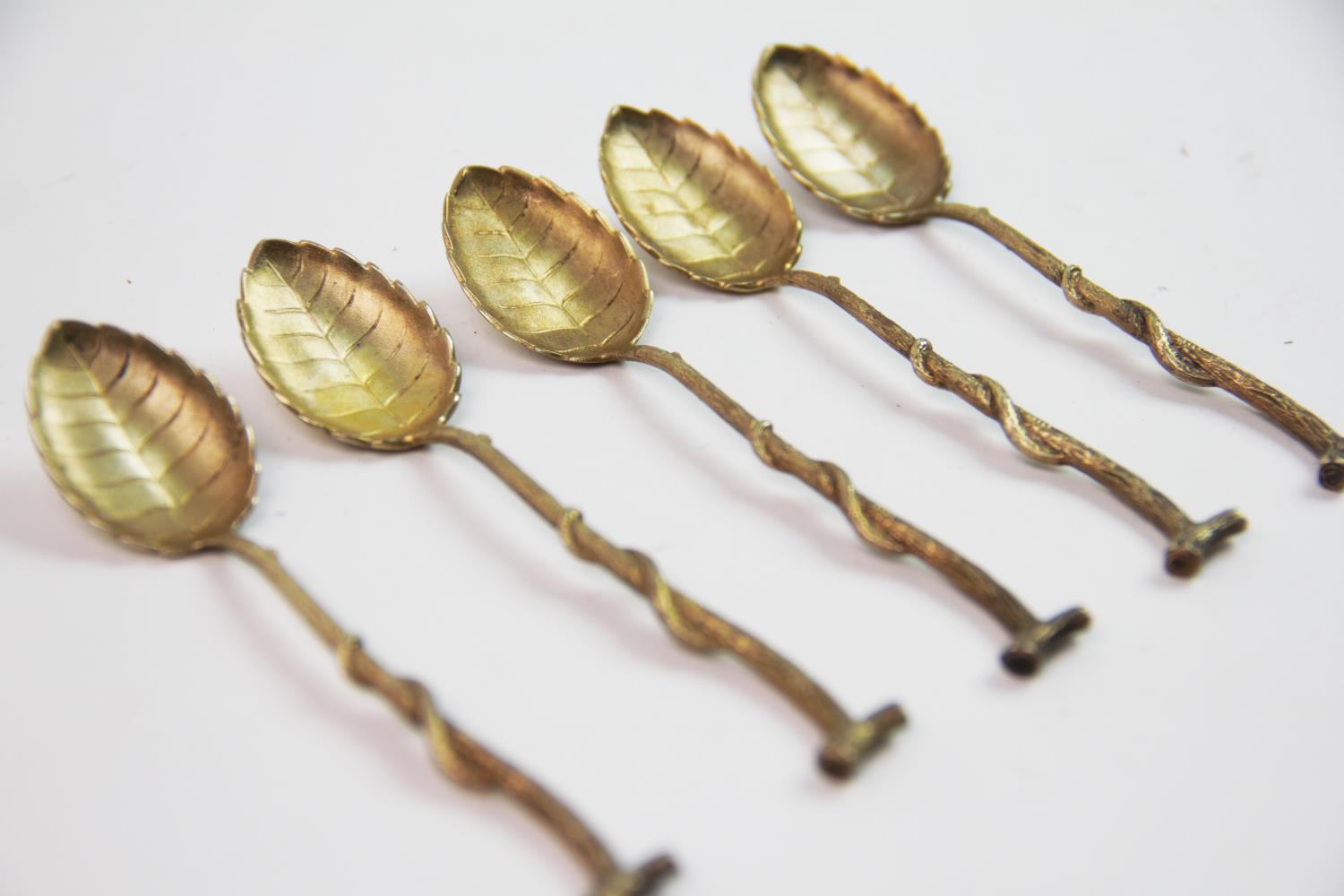 A set of eleven continental silver gilt teaspoons, the bowls designed as leaves, the handles of twig - Image 2 of 2