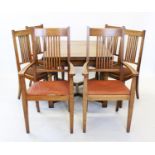 An early 20th century honey oak extending dining table, with a simulated cleated plank top above a