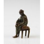A 19th century bronze Arabian figure, after Franz Bergman, designed as a seated man, cold painted,