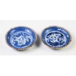 A pair of small Japanese blue and white Arita porcelain dishes, Meiji period, decorated with dragons