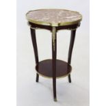 An early 20th century French rouge marble top occasional table, the circular marble top raised