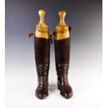 A pair of early 20th century black leather riding boots, with buckle detail, 45cm high and two beech