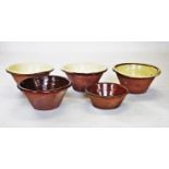 Five late 19th century glazed stoneware cream bowls, each of typical tapering form, three with a