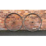 A pair of early 19th century trap/cart wheels, with iron hubs, spokes and rims, fitted with solid