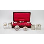 An Edwardian harlequin silver backed manicure set, comprising: two silver topped glass jars,