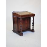 A Victorian walnut davenport, the satinwood interior with six small drawers, upon two ring turned