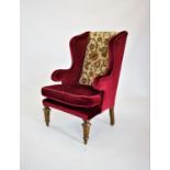 A 19th century gilt wood and gesso wing back armchair, the shaped and padded wing backs applied with