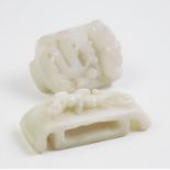 Two white jade coloured Chinese buckles, each of rectangular form and carved with dragons, 5.5cm and