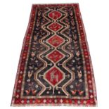 A deep ground Persian Hammadan Lori runner with a medallion door design, 305cm x 150cm