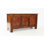 An 18th century oak six plank coffer,with a rectangular moulded top above a nulled frieze and