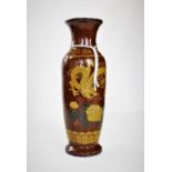 A Chinese floor vase, of baluster form, with a brown glaze, decorated as a phoenix and dragon amidst