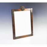 An Arts and Crafts mirror, the copper frame of rectangular form, with crescent shaped detail and