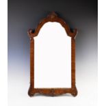 A Chippendale style mahogany wall mirror, early 20th century, with a shell crest above the arched