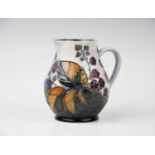 A Moorcroft jug of small proportions, decorated with the 'Bramble' design by Sally Tuffin,