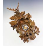 A mid 20th century West German carved oak cuckoo clock
