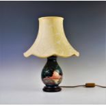A Moorcroft table lamp of baluster form, decorated with stylised balloon trees in a lakeland