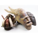 Three tribal masks, comprising: a West African Dogon mask, 81cm long, a Congo mask, 41cm high and