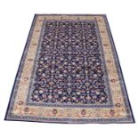 A blue ground Kashmir carpet, with an all-over floral design and gold border, 300cm x 200cm