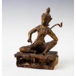 A Tibetan bronze model of Saraswati Gudinde, modelled seated playing a veena, 19cm high