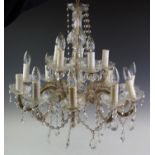 A gilt metal and glass droplet chandelier, 20th century, the baluster shaped central glass column