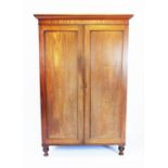 A Victorian mahogany two door wardrobe on turned legs 202cm high, 132cm wide, 63cm deep